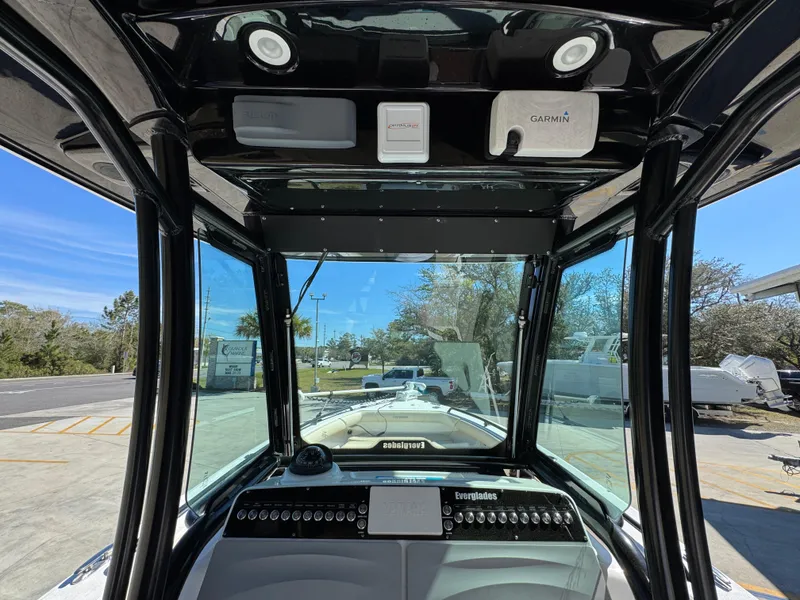 Slide: The Image of 2017 Everglades 273 Center Console boat interior with navigation equipment and clear windshield view. - 39