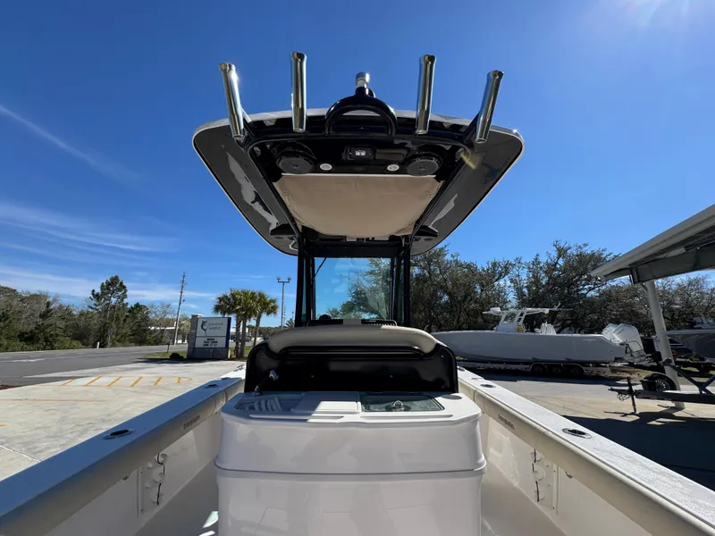Slide: The Image of 2017 Everglades 273 Center Console boat, view of helm and T-top under clear blue sky. - 42