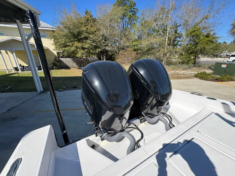 Slide: The Image of 2017 Everglades 273 Center Console with dual outboard engines in a driveway setting. - 46