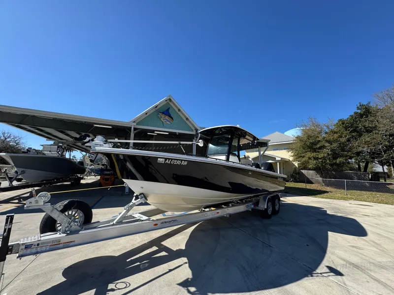 Slide: The Image of 2017 Everglades 273 Center Console boat on trailer under clear blue sky. - 5