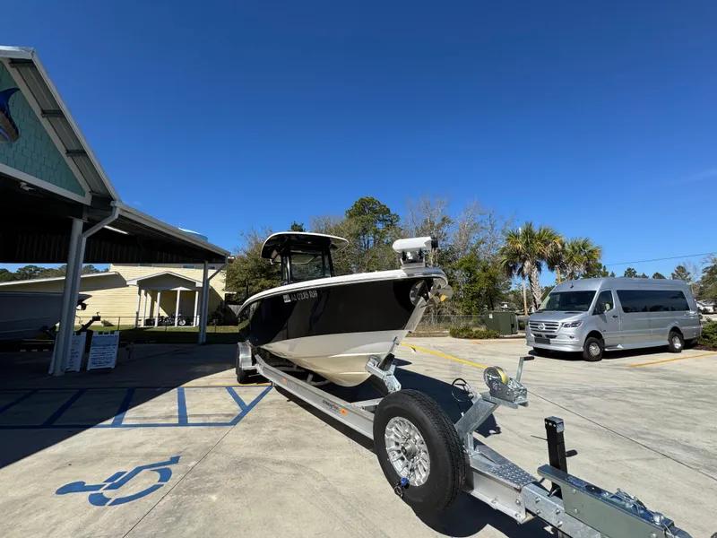 Slide: The Image of 2017 Everglades 273 Center Console boat on trailer, parked outdoors under clear blue sky. - 9