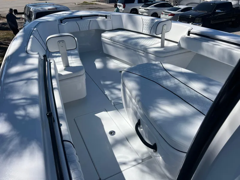 Slide: The Image of 2025 Contender 35 ST boat interior with white seating and sleek design. - 12