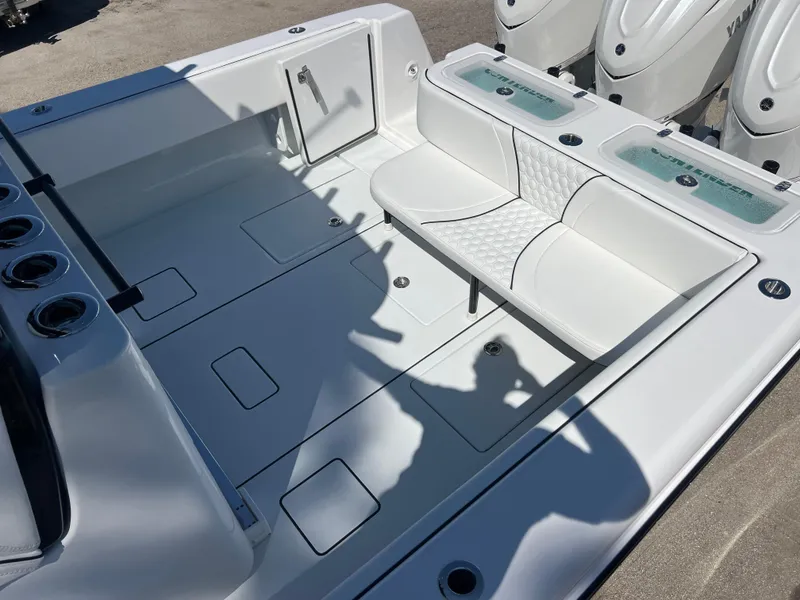 Slide: The Image of 2025 Contender 35 ST boat interior with white seating and storage compartments. - 15