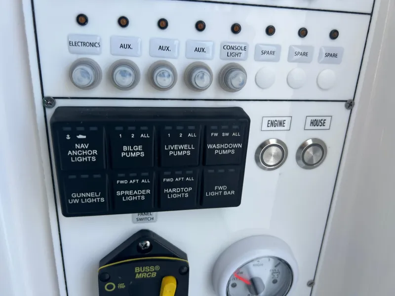 Slide: The Image of Control panel of 2025 Contender 35 ST boat with switches and gauges. - 18