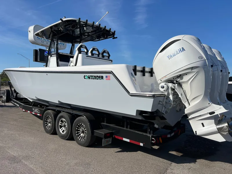 Slide: The Image of 2025 Contender 35 ST boat on trailer with Yamaha engines, parked outdoors. - 4