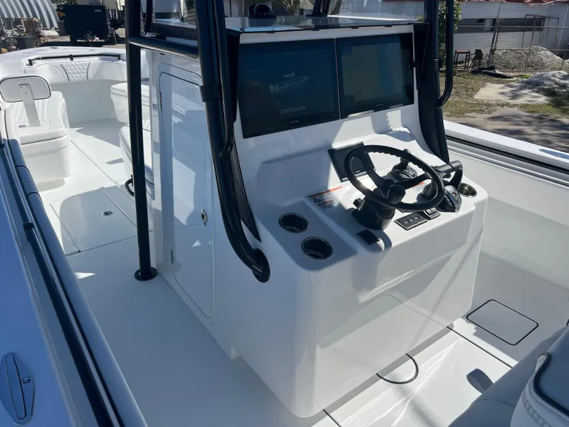 Slide: The Image of 2025 Contender 35 ST boat console with dual screens and steering wheel. - 8
