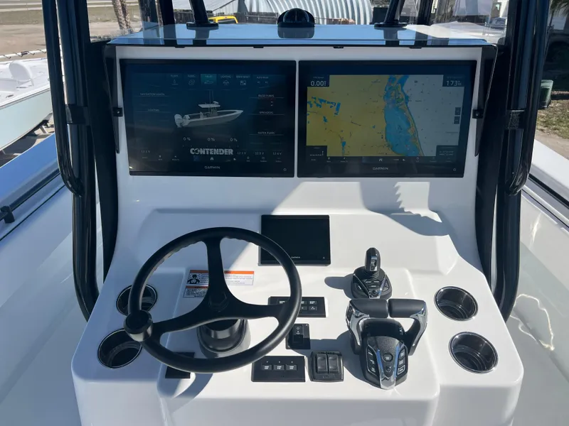 Slide: The Image of 2025 Contender 35 ST boat dashboard with dual navigation screens and steering wheel. - 9