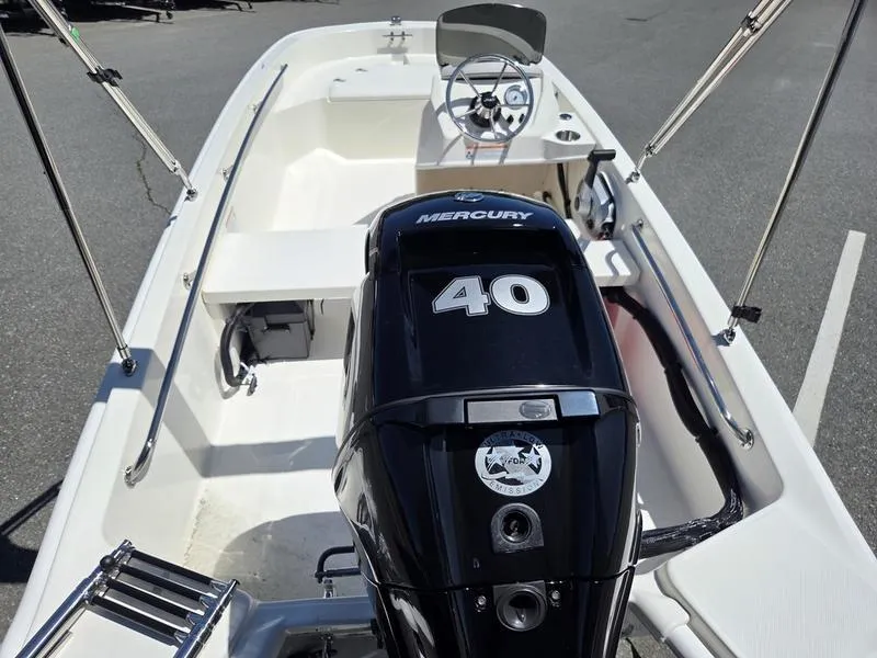 Slide: The Image of 2025 Boston Whaler 130 Super Sport boat with Mercury 40 engine, interior view. - 11