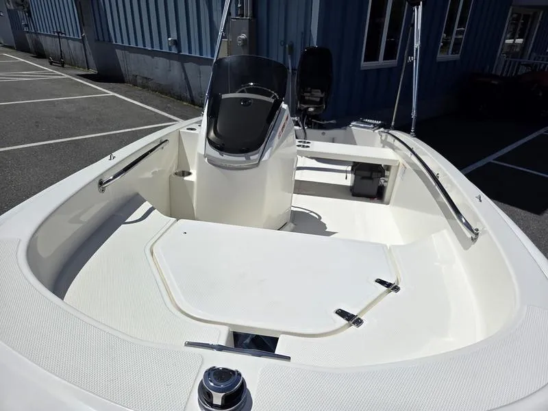 Slide: The Image of 2025 Boston Whaler 130 Super Sport boat interior with seating and console. - 6