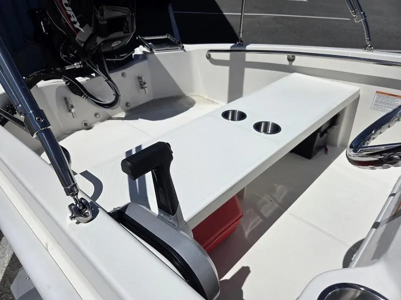Slide: The Image of 2025 Boston Whaler 130 Super Sport interior with seating and cup holders. - 9