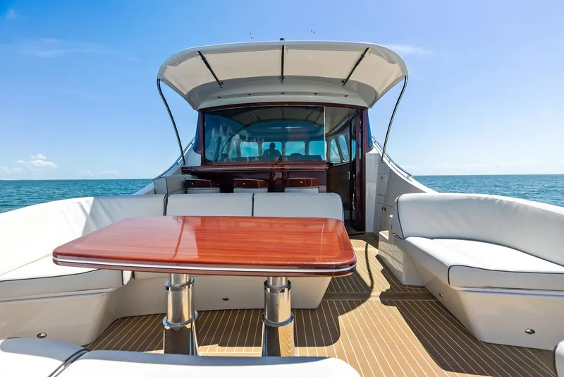 Slide: The Image of Luxurious 2019 Zeelander 55 yacht with elegant seating and wooden table on deck. - 15