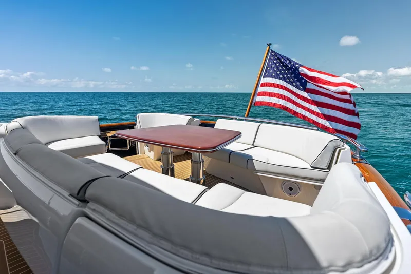 Slide: The Image of Luxurious 2019 Zeelander 55 yacht with American flag, ocean view, and elegant seating area. - 19