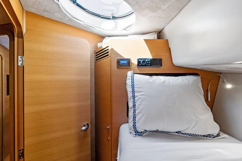 Slide: The Image of Cozy cabin interior of 2019 Zeelander 55 yacht with wooden finish and bedding. - 42