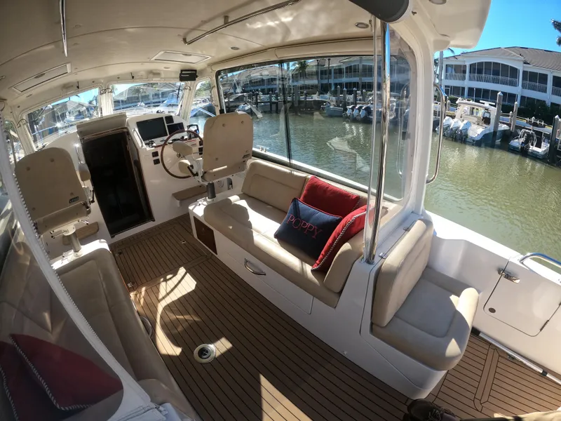 Slide: The Image of 2018 MJM 35z yacht interior with seating, helm, and marina view. - 17