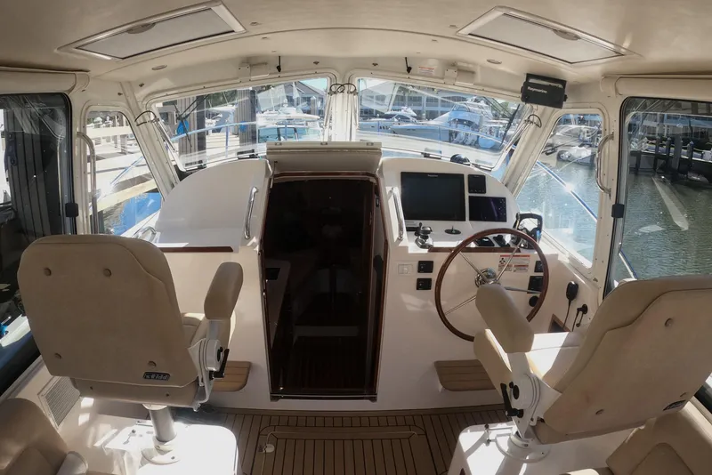 Slide: The Image of Interior view of 2018 MJM 35z boat cockpit with steering wheel and seating. - 21