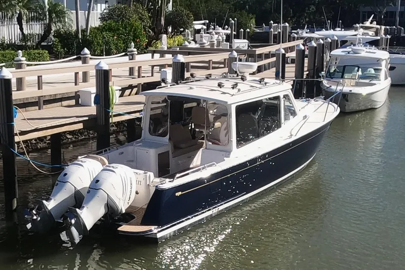 Slide: The Image of 2018 MJM 35z boat docked with twin outboard engines in a marina. - 3