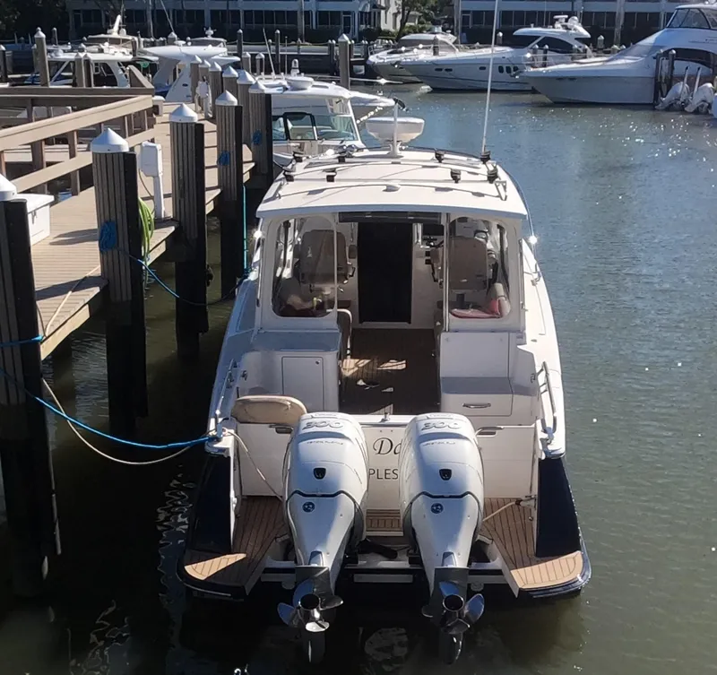Slide: The Image of 2018 MJM 35z boat docked with twin outboard engines in a marina. - 6