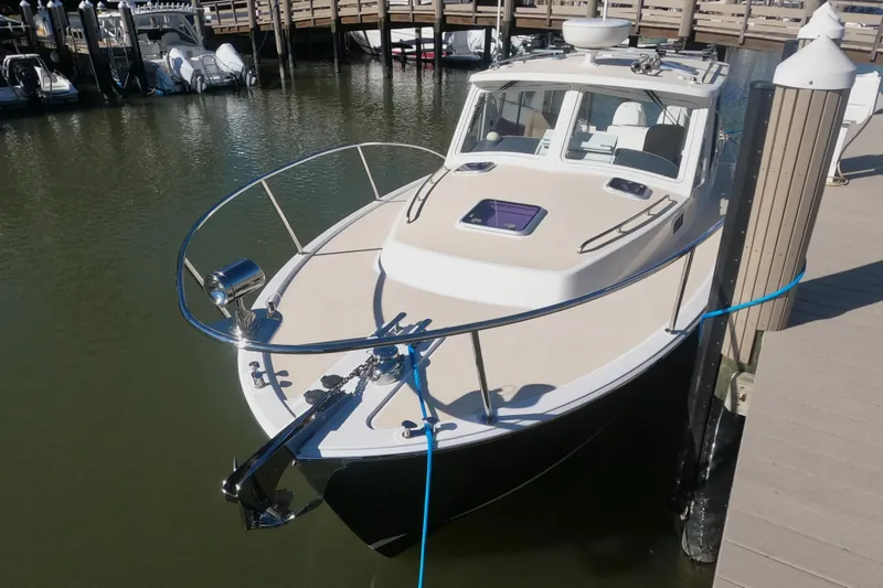 Slide: The Image of 2018 MJM 35z boat docked at marina, featuring sleek design and modern amenities. - 7