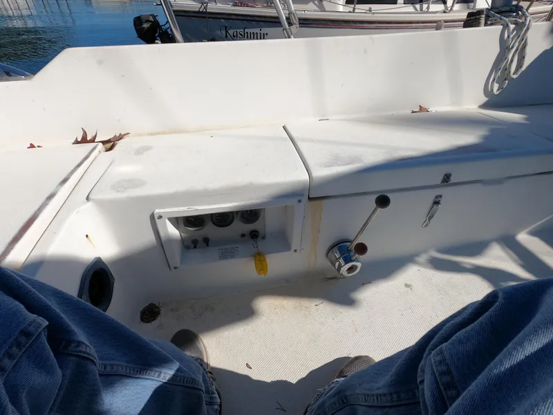 Slide: The Image of Cockpit view of a 1983 Catalina 27 sailboat with control panel and seating. - 4