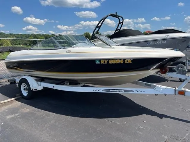 The Image of 2001 Wellcraft 175SS boat on trailer under blue sky with clouds. - 1