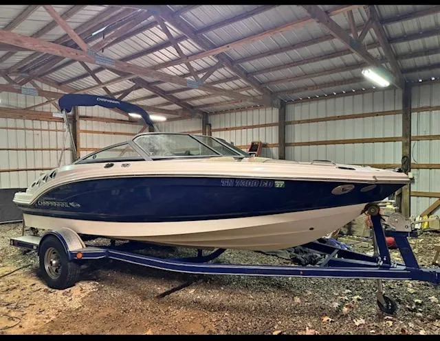 The Image of 2012 Chaparral 196 SSi boat on trailer in a metal storage shed. - 0