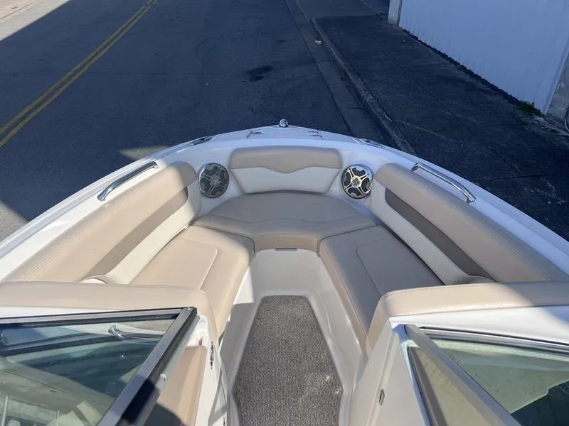 Slide: The Image of 2012 Chaparral 196 SSi boat interior with beige seating and speakers. - 10