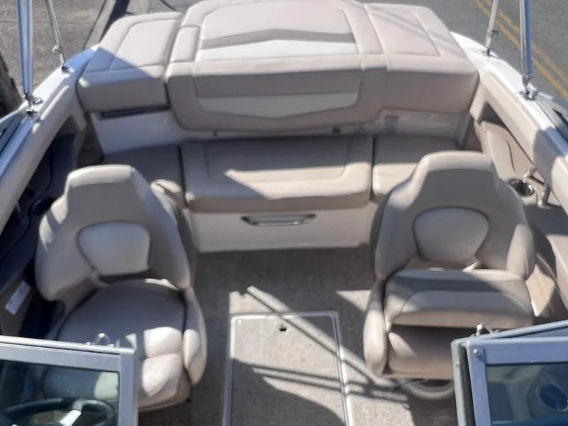 Slide: The Image of Interior of a 2012 Chaparral 196 SSi boat with beige seating and carpeted floor. - 12