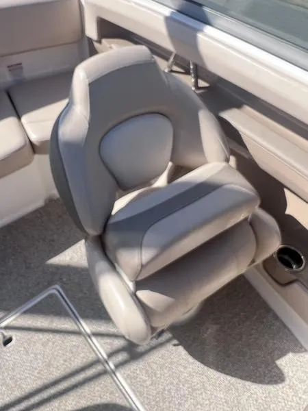 Slide: The Image of 2012 Chaparral 196 SSi boat seat, beige upholstery, cup holder, and carpeted floor. - 14