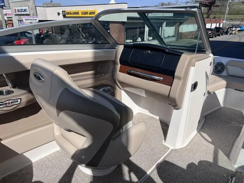 Slide: The Image of Interior of a 2012 Chaparral 196 SSi boat with beige seating and dashboard. - 15
