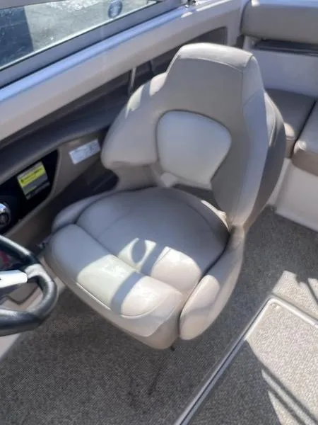 Slide: The Image of 2012 Chaparral 196 SSi boat interior with gray captain's seat and steering wheel. - 16