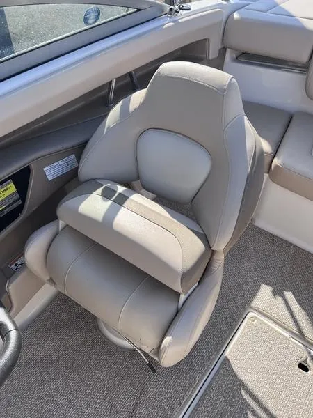 Slide: The Image of 2012 Chaparral 196 SSi boat interior with beige seating and carpeted flooring. - 17