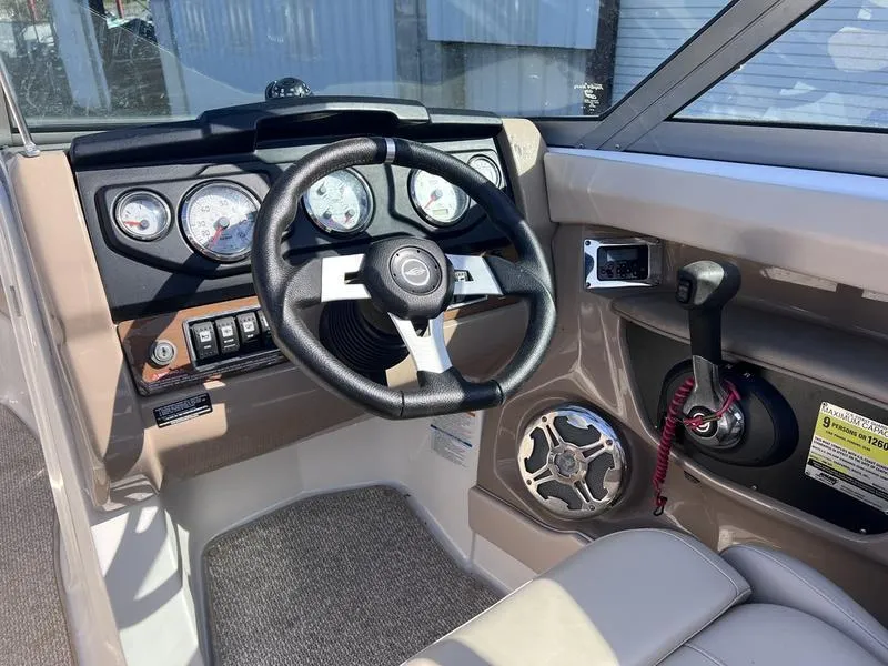 Slide: The Image of Interior of 2012 Chaparral 196 SSi boat, featuring steering wheel and control panel. - 18