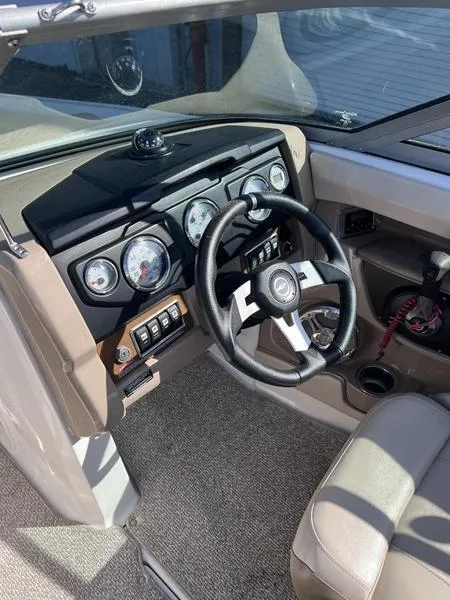 Slide: The Image of 2012 Chaparral 196 SSi boat dashboard with steering wheel and gauges. - 19