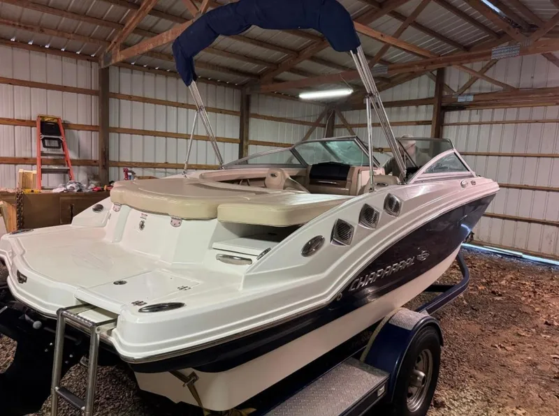Slide: The Image of 2012 Chaparral 196 SSi boat in a wooden storage shed. - 2
