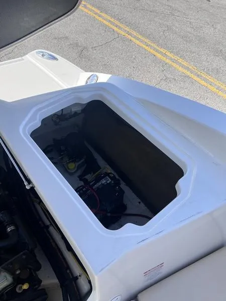 Slide: The Image of 2012 Chaparral 196 SSi boat storage compartment with visible battery and wiring. - 25