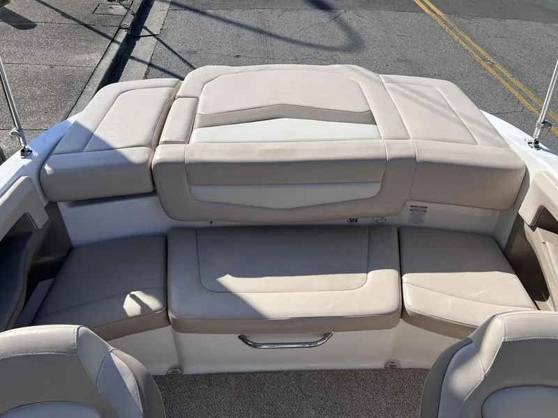 Slide: The Image of 2012 Chaparral 196 SSi boat interior with beige seating and storage compartment. - 26