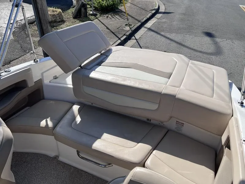 Slide: The Image of 2012 Chaparral 196 SSi boat interior with beige seating and sun pad. - 27