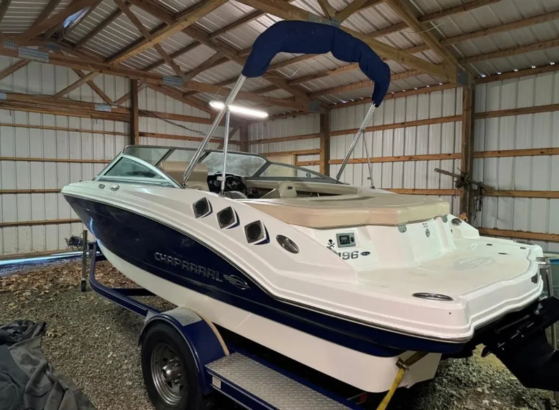 Slide: The Image of 2012 Chaparral 196 SSi boat in a storage shed, on a trailer. - 3