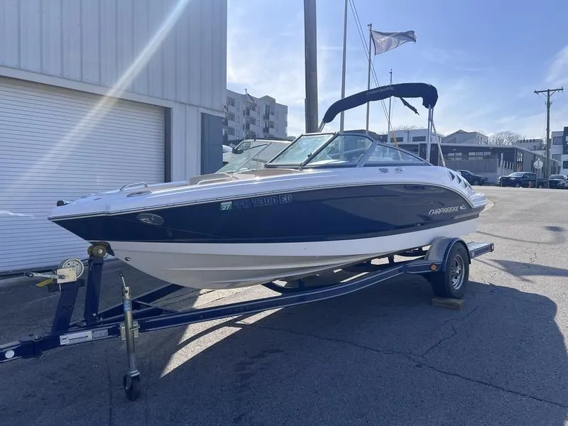 Slide: The Image of 2012 Chaparral 196 SSi boat on trailer, parked outdoors in a sunny setting. - 6