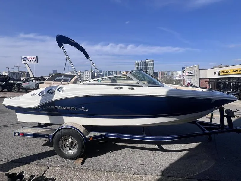 Slide: The Image of 2012 Chaparral 196 SSi boat on trailer, parked outdoors under clear sky. - 7