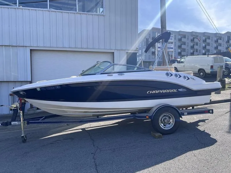 Slide: The Image of 2012 Chaparral 196 SSi boat on trailer, parked outside a building. - 8