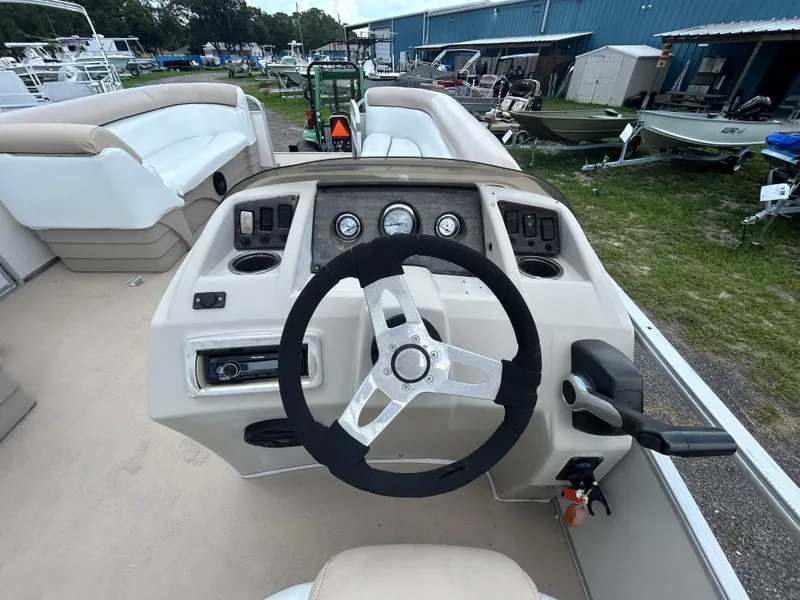 Slide: The Image of 2014 Bennington S22 Saltwater Series boat dashboard with steering wheel and controls. - 14