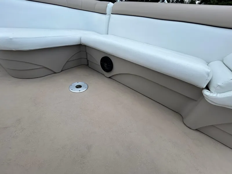Slide: The Image of 2014 Bennington S22 Saltwater Series boat interior with beige seating and speaker. - 17