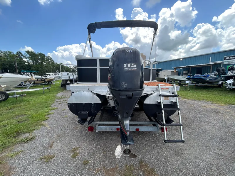 Slide: The Image of 2014 Bennington S22 Saltwater Series pontoon boat with 115 HP engine, parked outdoors. - 3