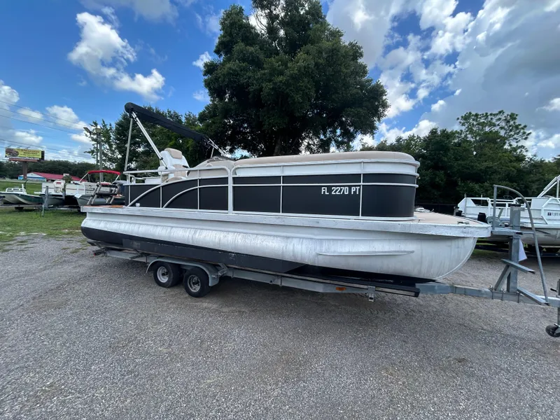 Slide: The Image of 2014 Bennington S22 Saltwater Series pontoon boat on trailer, parked outdoors under cloudy sky. - 5