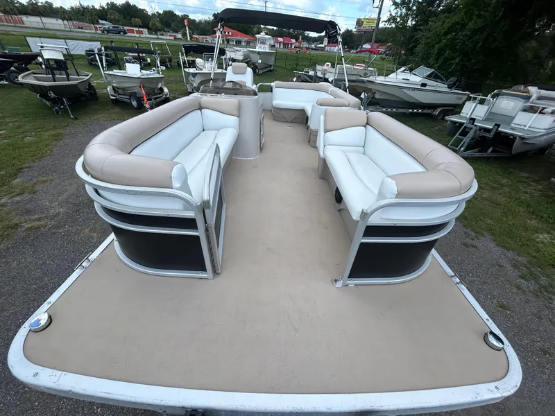 Slide: The Image of 2014 Bennington S22 Saltwater Series pontoon boat with spacious seating, parked outdoors. - 6