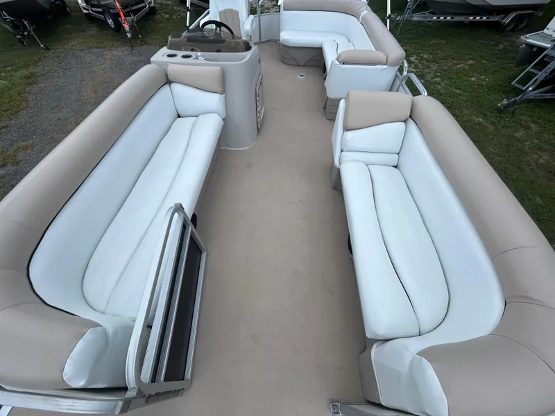 Slide: The Image of 2014 Bennington S22 Saltwater Series pontoon boat interior with beige and white seating. - 7