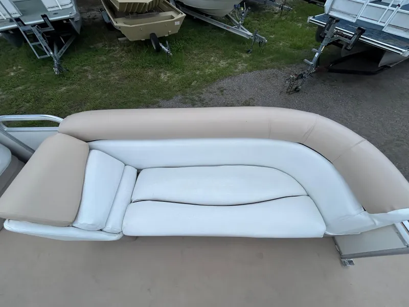 Slide: The Image of 2014 Bennington S22 Saltwater Series boat seating, beige and white upholstery, outdoor setting. - 8