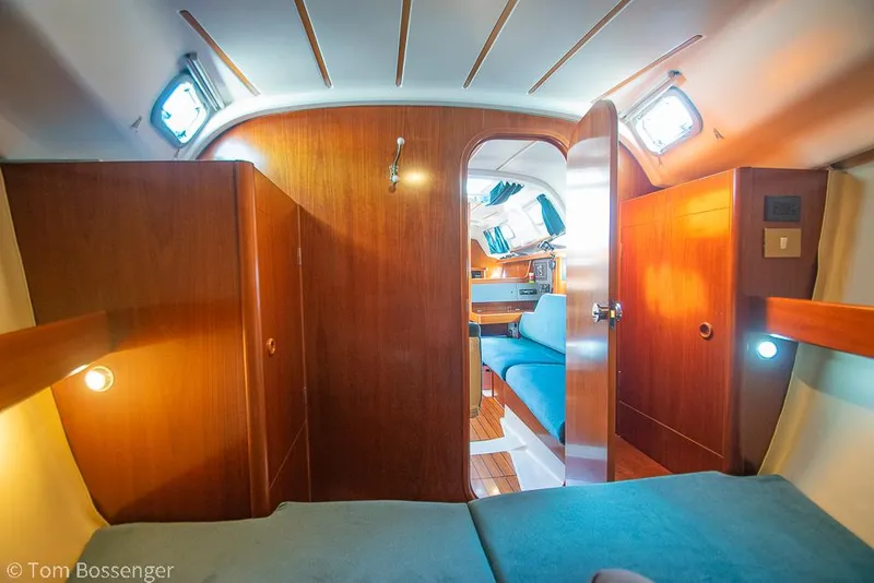 Slide: The Image of Interior of 1995 Beneteau Oceanis 35.1 sailboat, featuring cozy wooden cabin and seating area. - 18