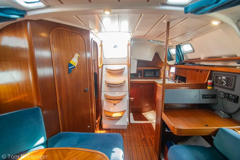 Slide: The Image of Interior of 1995 Beneteau Oceanis 35.1 sailboat with wood finish and blue seating. - 19